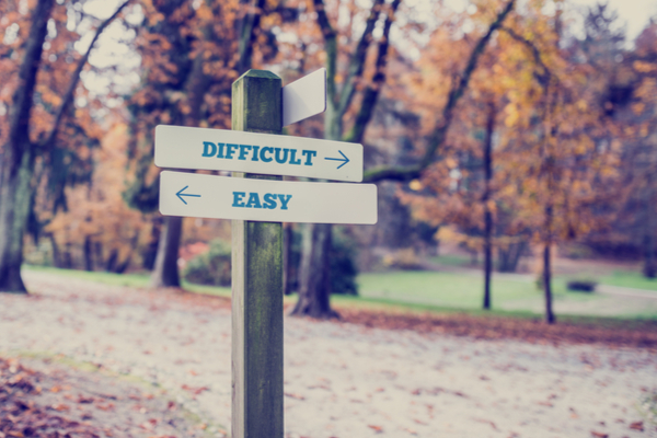 A bi-directional signpost showing "easy" and "difficult" paths, symbolizing how brain fog can make decisions feel overwhelming