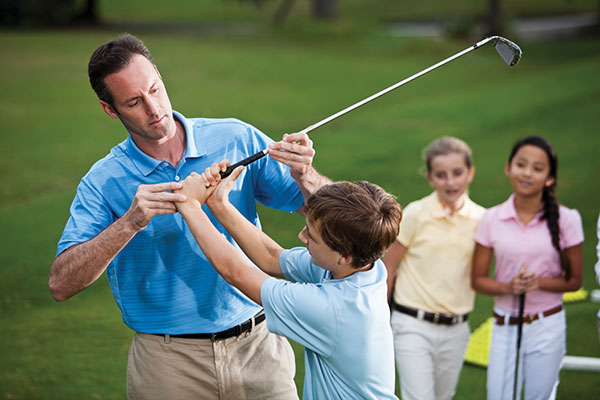 instructor teaching kids how to golf instructor teaching kids how to golf
