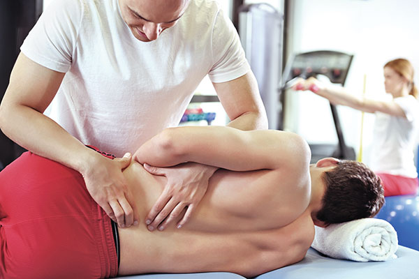 man receiving treatment from a chiropractor